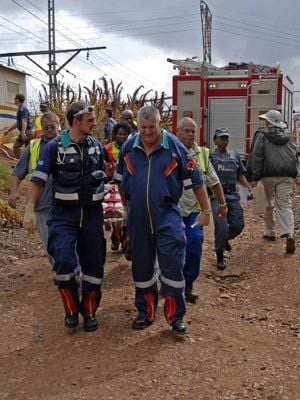 Emergency services workers carry a passenger injured in the Rovos Rail accident in Pretoria to an ambulance. Photo: Netcare/Sapa