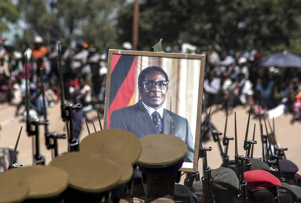 Members of the combined defence forces parade carry a portrait of President Robert Mugabe during Zimbabwes 29th Independence celebrations in Bulawayo on April 18 2009. Emmanuel Chitate, Reuters