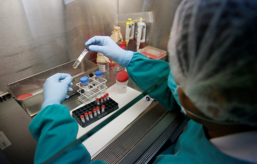 Solutions: A health technician analyses blood samples for tuberculosis in a high-tech TB lab in Lima