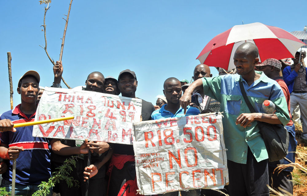 Striking miners gather at Harmony Gold's Kusasalethu mine for a mass meeting to hear from Liv Shange.