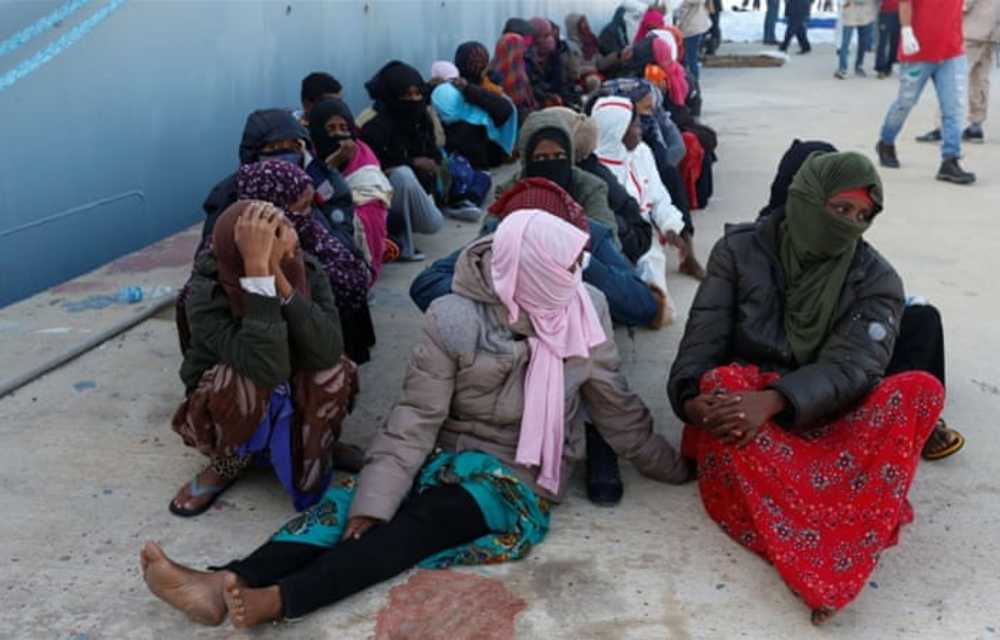 Migrants arrive at a naval base after they were rescued by Libyan coastal guards in Tripoli