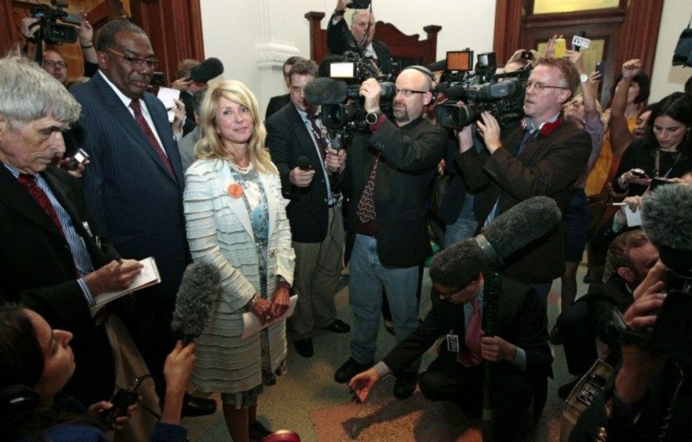 State senator Wendy Davis is surrounded by media after the Democrats defeated the anti-abortion bill SB5