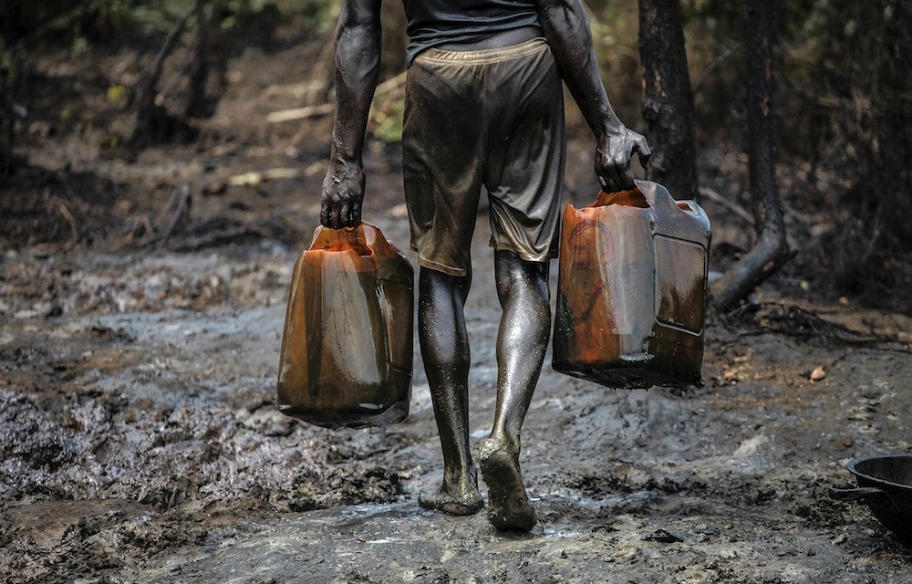 Oil bunkering: A man works at an illegal oil refinery near the Nun River in Nigeria’s oil state of Bayelsa.