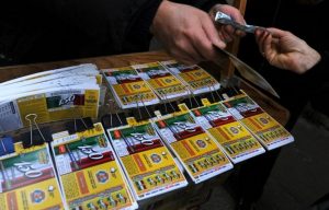 A woman buys lottery tickets at a street seller on January 5