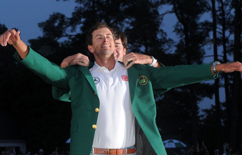 Bubba Watson of the US presents Adam Scott with a green jacket during the Green Jacket Ceremony at 77th Masters golf tournament at Augusta National Golf Club.