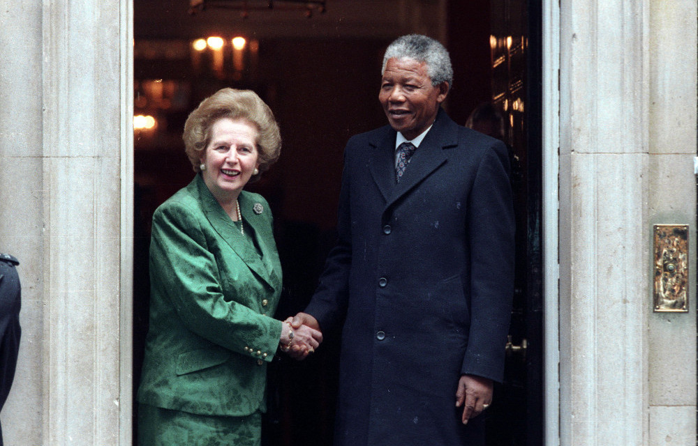 Then-ANC leader Nelson Mandela is greeted by British Prime Minister Margaret Thatcher at 10 Downing Street on July 4