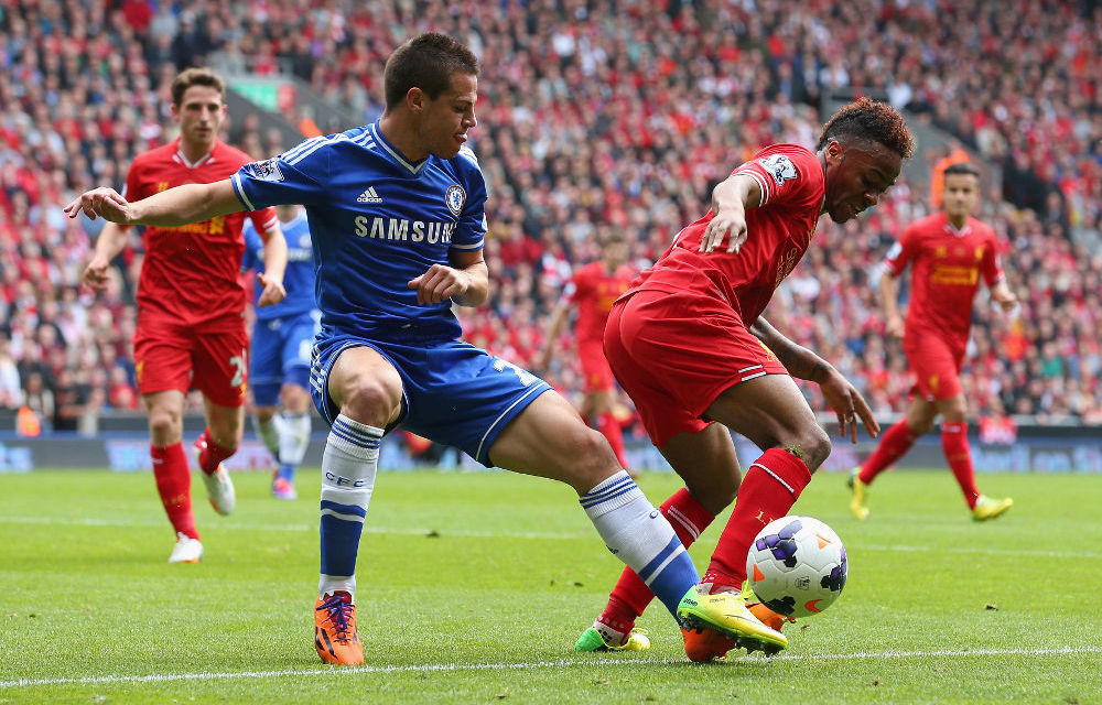 Cesar Azpilicueta of Chelsea marshalls Raheem Sterling of Liverpool during the Barclays Premier League match between Liverpool and Chelsea.