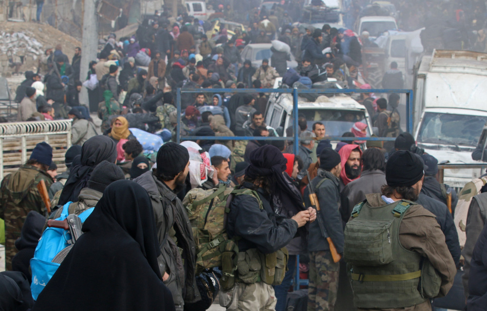 ebel fighters and civilians wait to be evacuated from a rebel-held sector of eastern Aleppo.