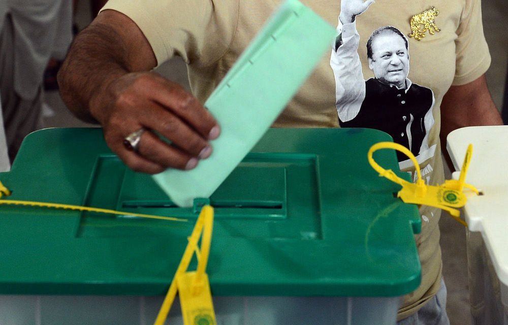 A supporter of former Pakistan prime minister Nawaz Sharif casts his vote at a polling station in Lahore.