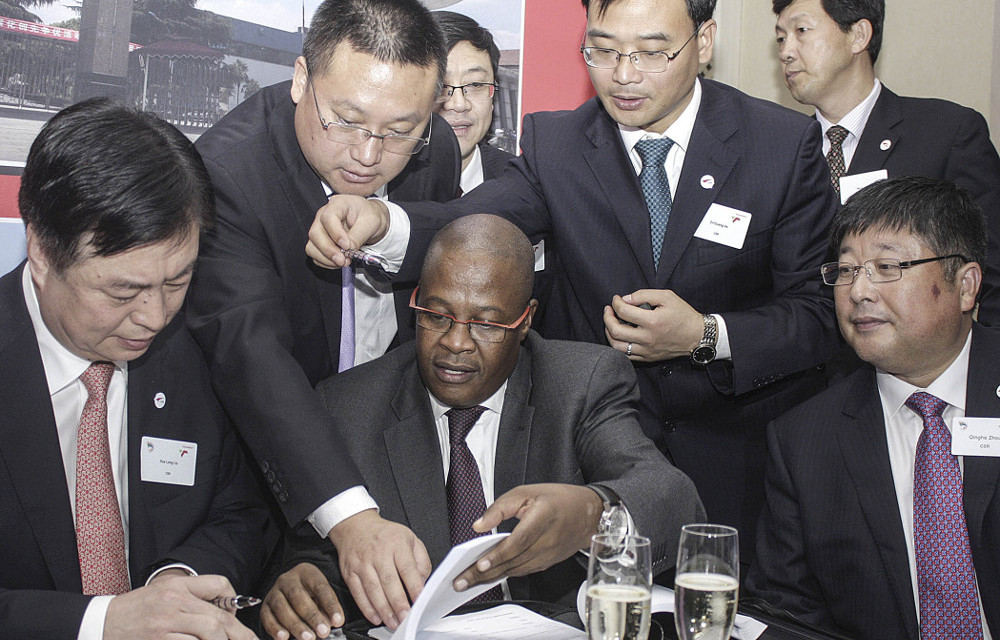 Rolling start: Then Transnet chief executive Brian Molefe signs off a deal with a Chinese company to build locomotives for the parastatal.