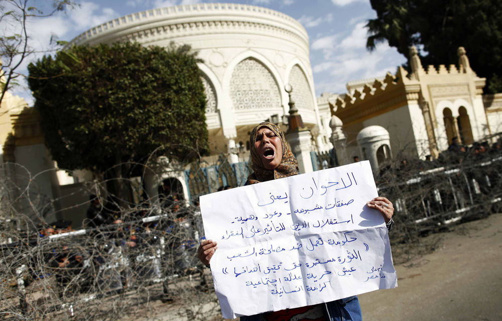 Clashes between stone-throwing youths and the police continued in streets near Cairo's Tahrir Square.