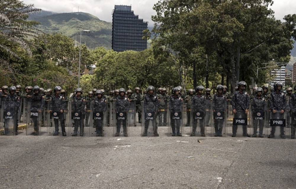 Bolivarian National Police officers stand guard in front Universidad Central de Venezuela during opposition protest against President Nicolas Maduro in Caracas