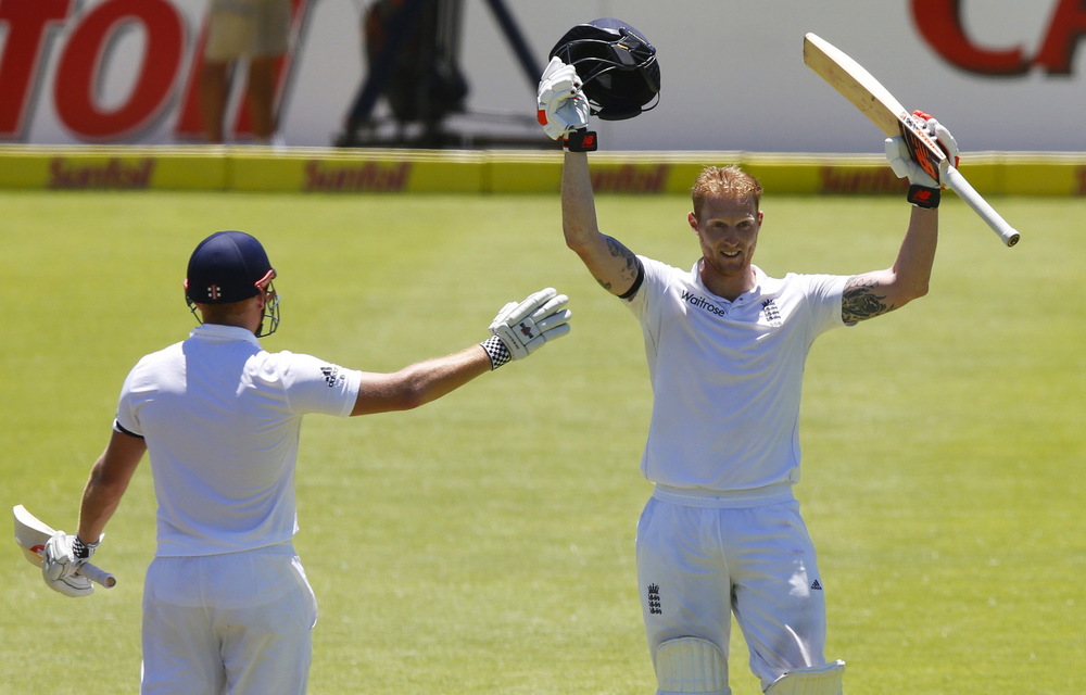 England's Ben Stokes celebrates scoring a double century with Jonny Bairstow during the second cricket test match against South Africa in Cape Town.