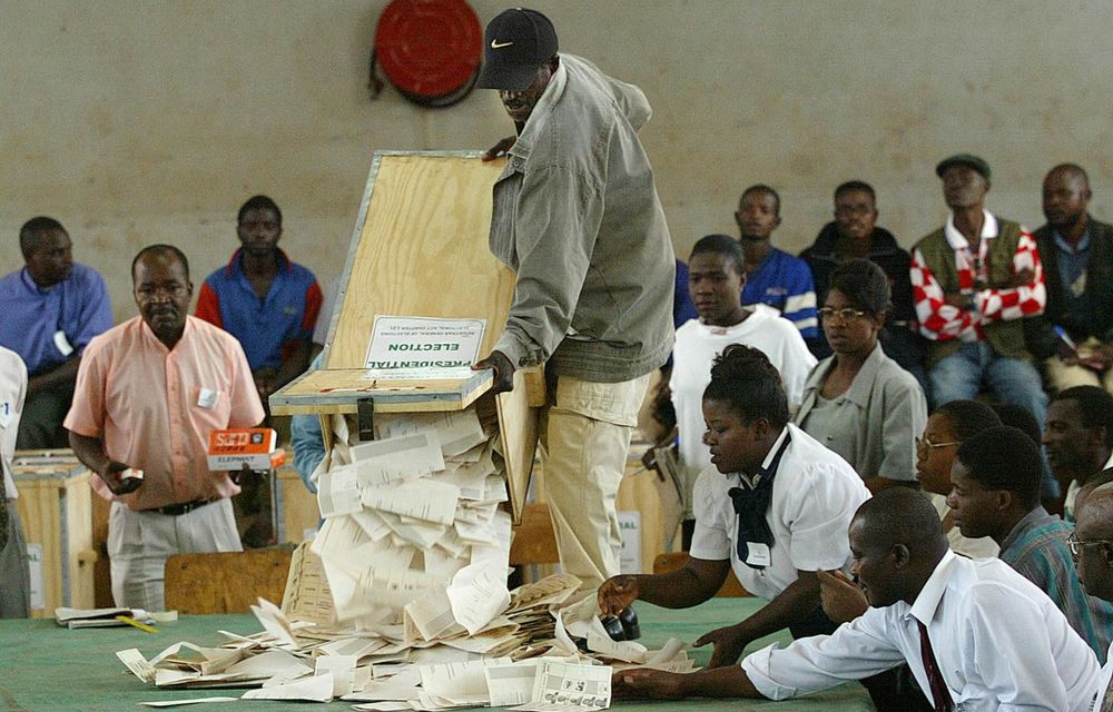 Officials from the Zimbabwe Electoral Commission count ballots after a special vote by security forces.