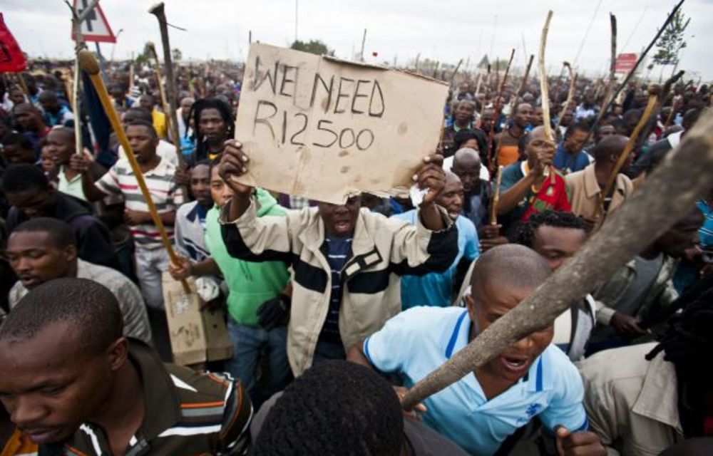 Miners at Marikana protest in 2012. Their poor living conditions were exposed by the Farlam inquiry.