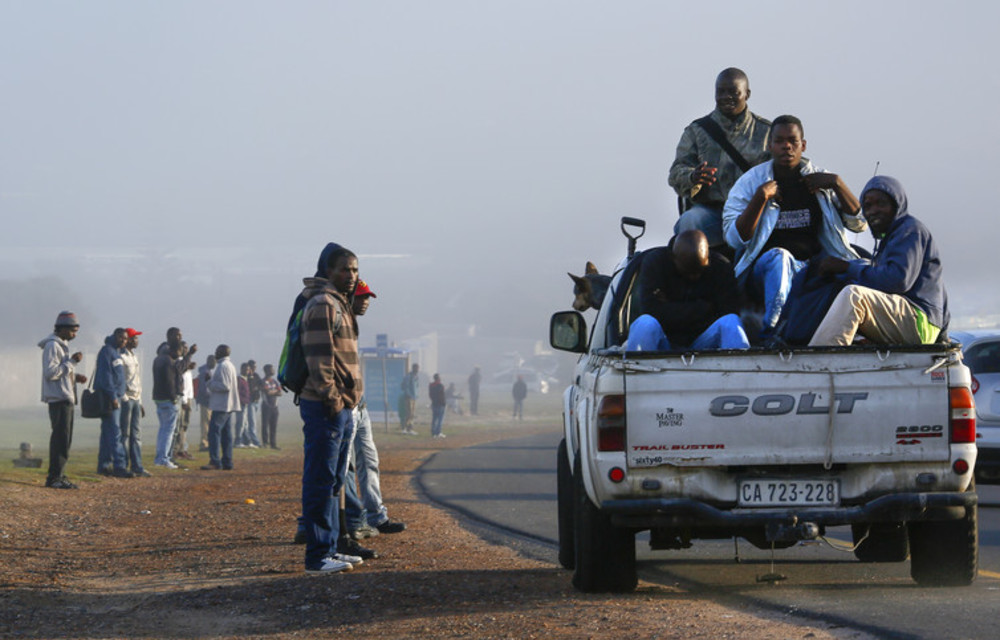 Unemployed South African workers wait for scarce jobs as the economy struggles to create employment.