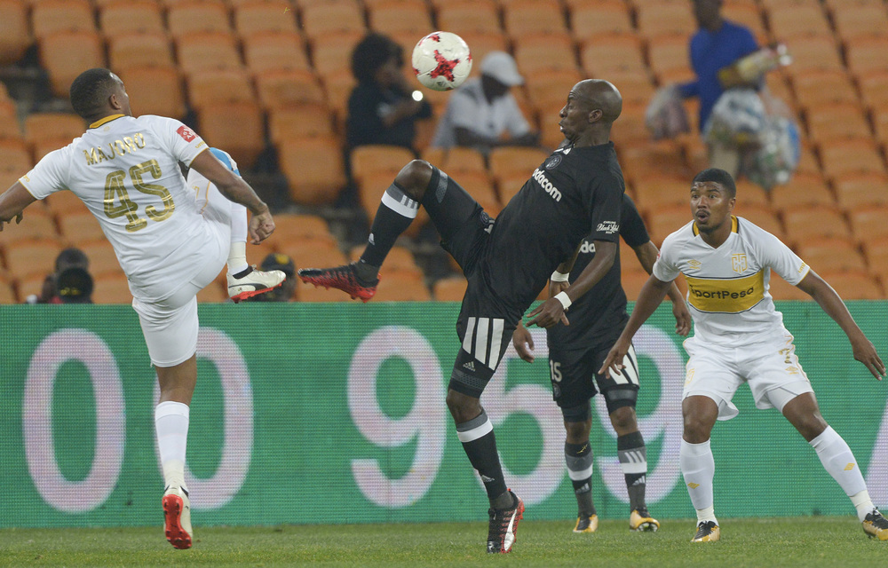 Musa Nyatama of Orlando Pirates fights for the ball with Lehlohonolo Majoro of Cape Town City.