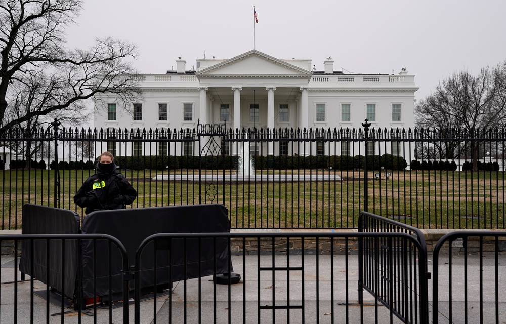 A Secret Service officer maintains watch during the partial government shutdown at the White House.