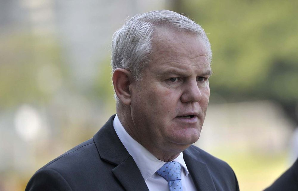 The state has withdrawn charges against two men accused of trying to bribe the Hawks's Johan Booysen.