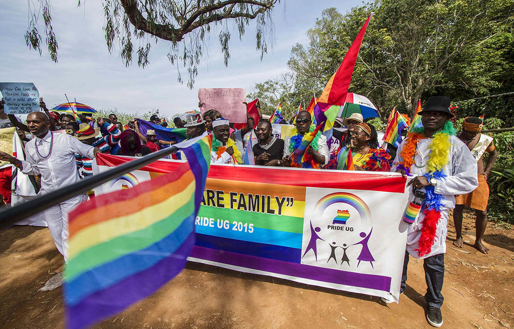 Participants hold rainbow flags during the Gay Pride parade in Entebbe