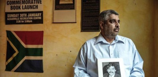 Justice delayed: Imtiaz Cajee holds a portrait of Ahmed Timol. Despite being hamstrung by officialdom