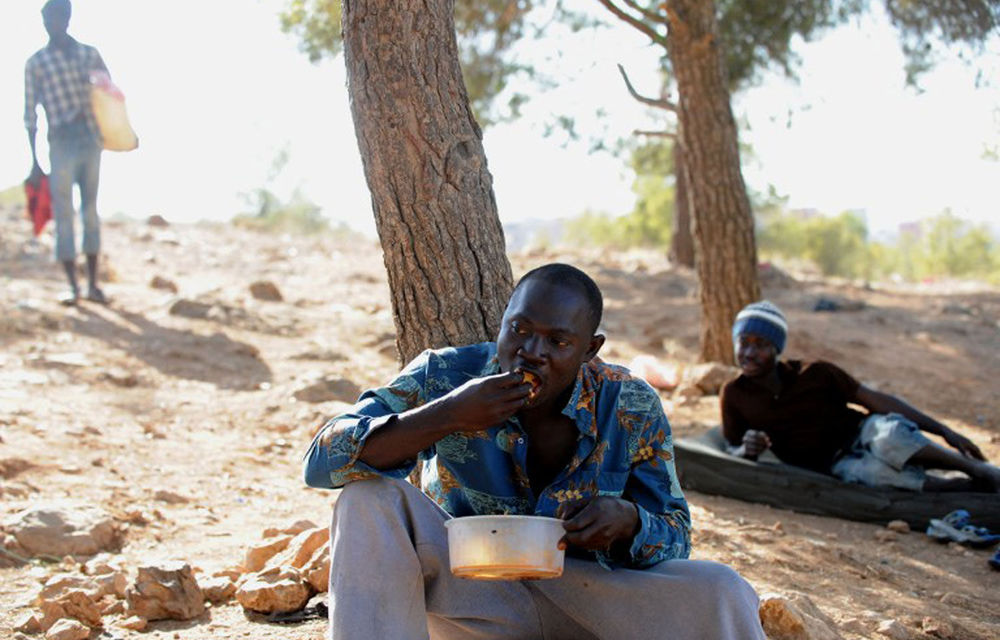 An illegal African immigrant resting at a makeshift camp in the Sidi Maafa woods in Oujda near Morocco's Mediterranean coast on September 10 2012.