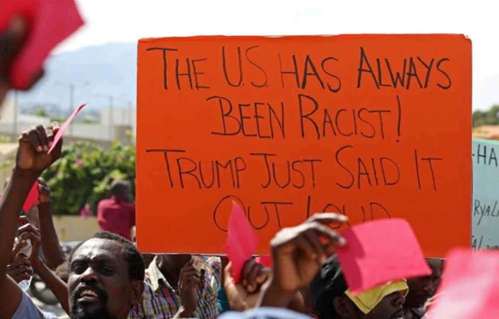 Haitians gather outside the US embassy in Port-au-Prince to protest against reported comments made by Donald Trump against the countries of the Caribbean and Africa.