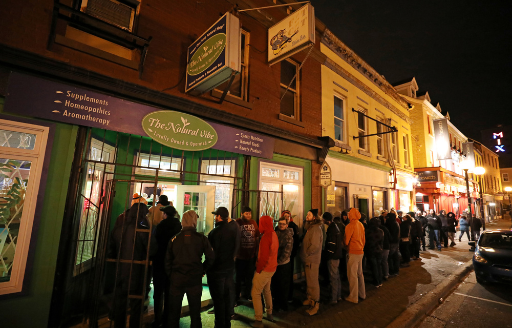 Customers line up outside the Natural Vibe store after legal recreational marijuana went on sale in St John's