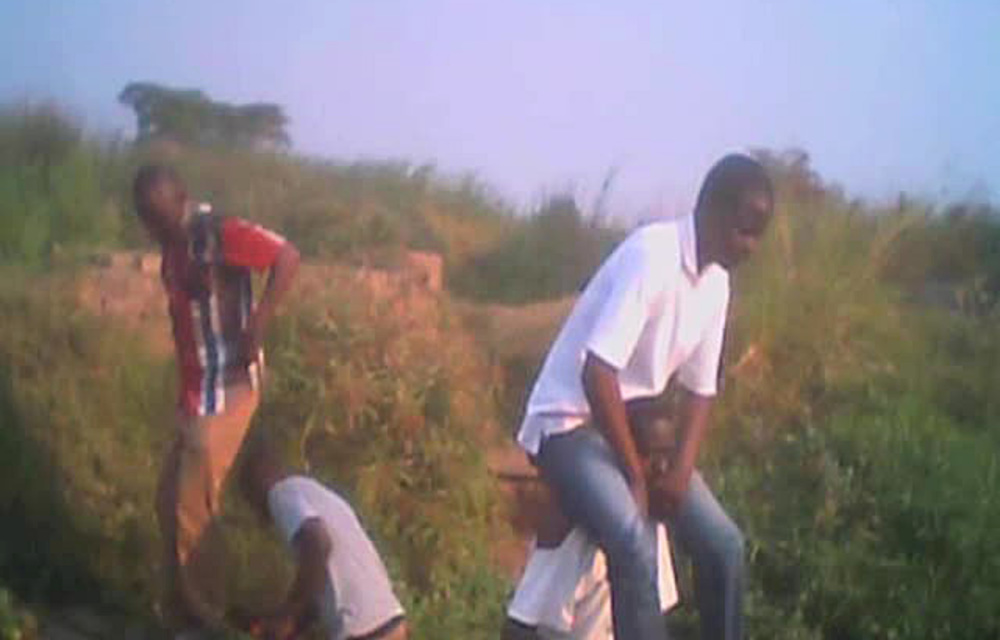 Two unemployed Zimbabweans are earning a living by helping piggyback people cross the Mukuvisi River in the industrial area of Harare.