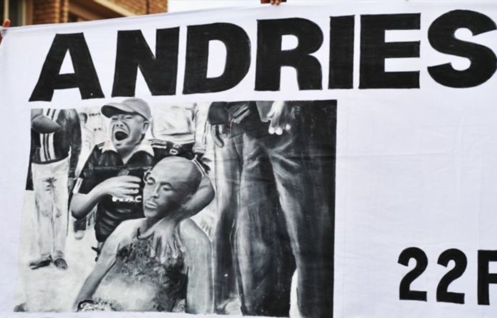 Protestors hold up a banner outside the magistrates court in Ficksburg