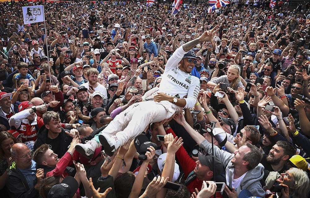 Lewis Hamilton crowd surfs after winning the British Grand Prix last year. He will be gunning for his fourth world title this year. Photo: Clive Mason/Getty Images