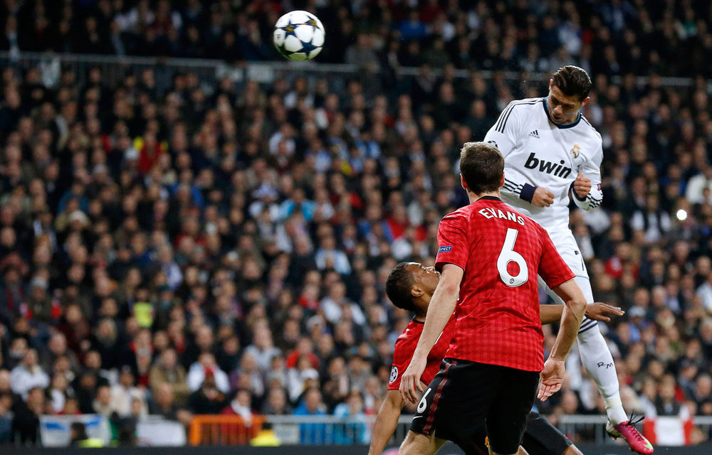 Real Madrid's Portuguese forward Cristiano Ronaldo heads the ball to score during a Uefa Champions League round of 16 first leg football match against Manchester United in Madrid on February 13 2013.