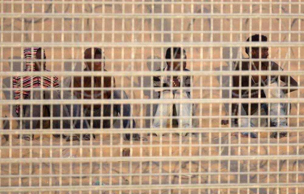 A group of African migrants seen on September 6 2012 behind the border fence after being trapped for seven days between fences on the Israel-Egyptian border.