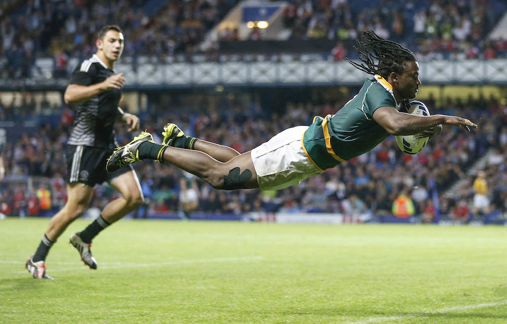 Legend in the making: Winger Seabelo Senatla in full flight as he scores one of his 189 tries for the Blitzboks. Photo: Russell Cheyne/Reuters