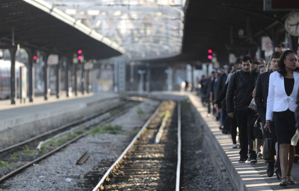 Commuters arrive by train during a strike by French SNCF railway workers at the Gare de l'Est station in Paris.