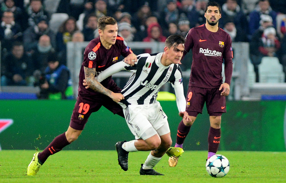 Juventus’ Paulo Dybala in action with Barcelona’s Lucas Digne.