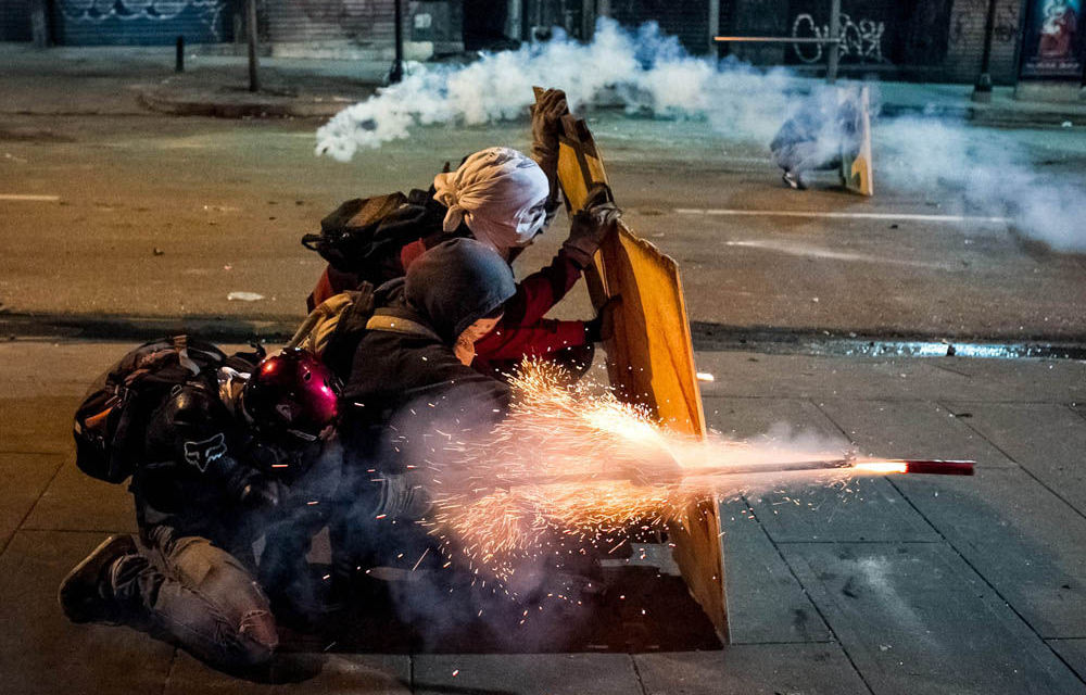 Opposition demonstrators clash with the Venezuelan police in Caracas. The opposition wants certain conditions to be met before accepting the offer of President Nicolas Maduro to talk.