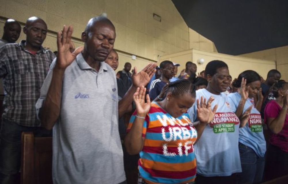 Church of God congregants await spiritual healer Samuel Radebe.