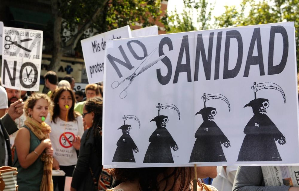 People hold a reading "No cuts in health" as they take part in a demonstration against the Spanish government's latest austerity measures.