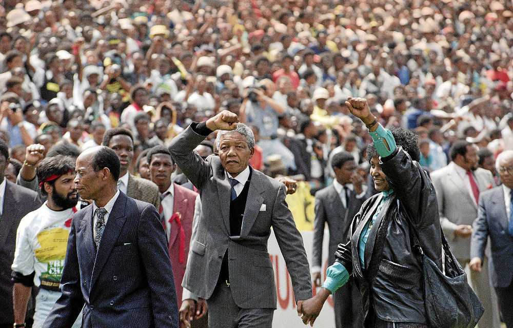 Sage warrior: Nelson and Winnie Mandela salute onlookers on entering the FNB Stadium in Soweto after his release in 1990