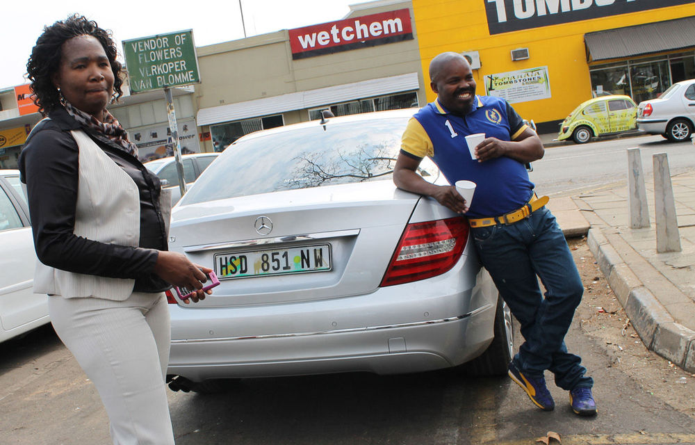 North West  ANC secretary Tokkie Mataboge stands near  his luxurious Mercedes Benz.