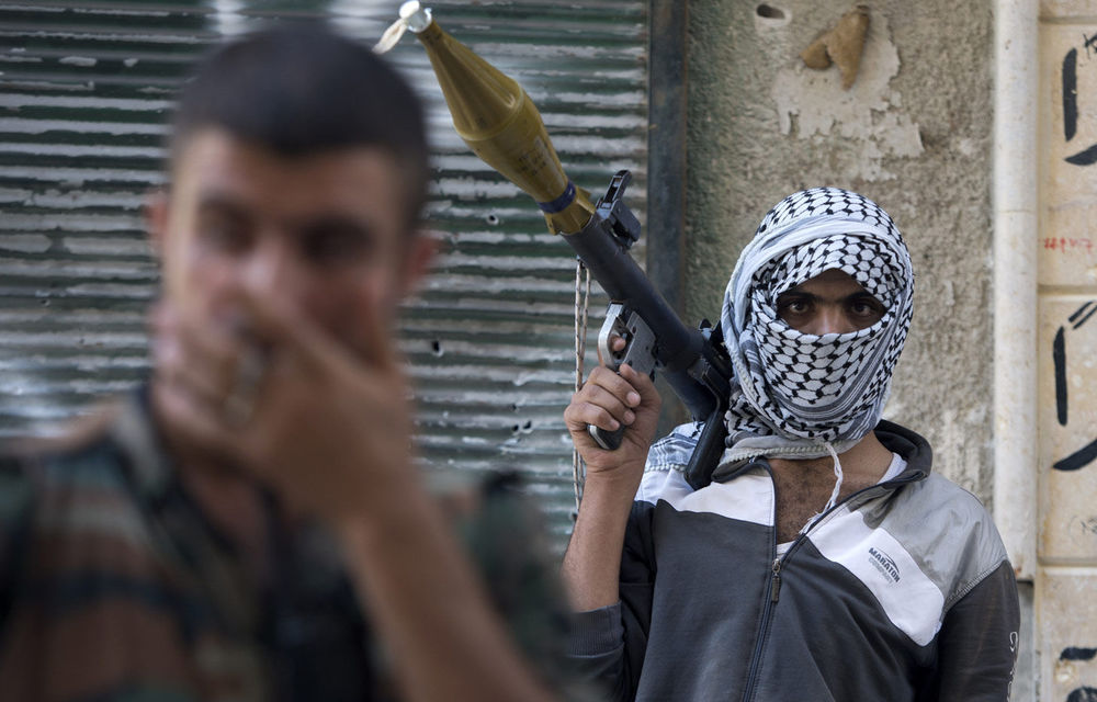 Syrian rebels hold their position as they try to root out Syrian government forces in the Amariya neighbourhood of Aleppo.