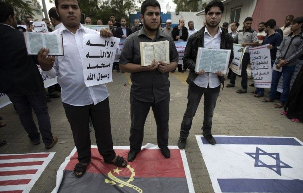 People hold copies of the Koran