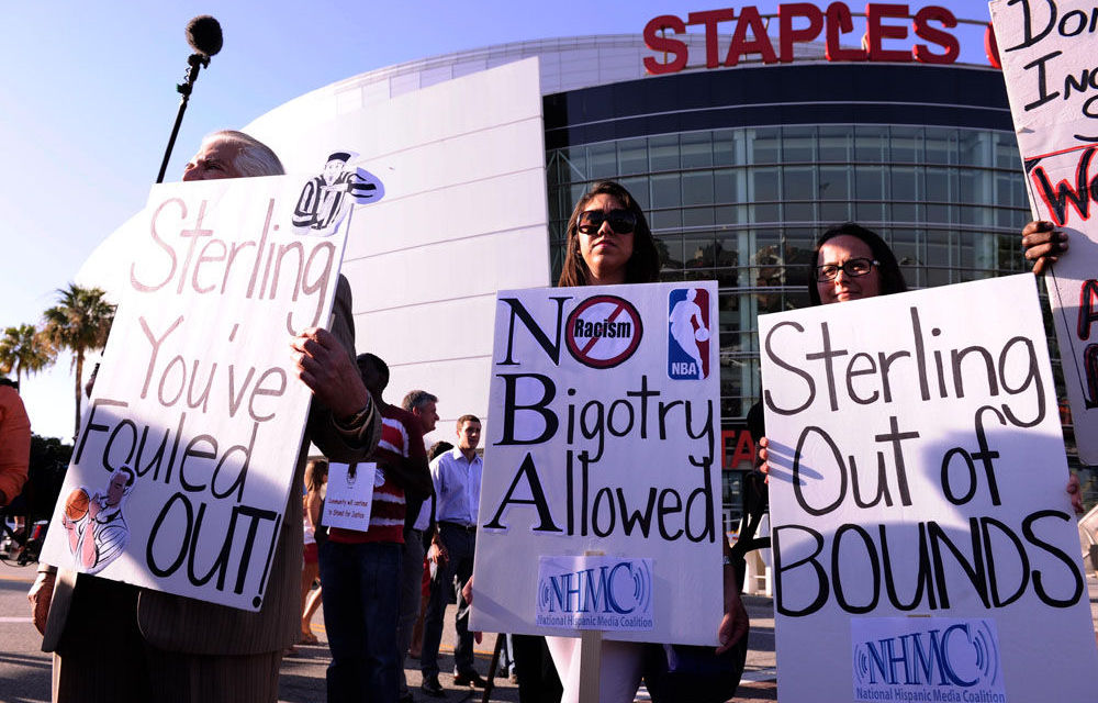 Demonstrators hold up signs in front of Staples Centre demanding the sale of the Los Angeles Clippers prior to game five of the first round of the 2014 NBA Playoffs.