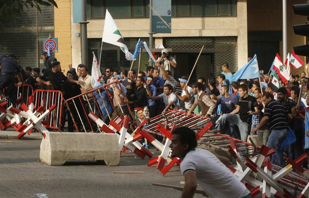 The funeral of an assassinated Lebanese intelligence chief ended in violence as mourners broke away and tried to storm the prime minister's offices.