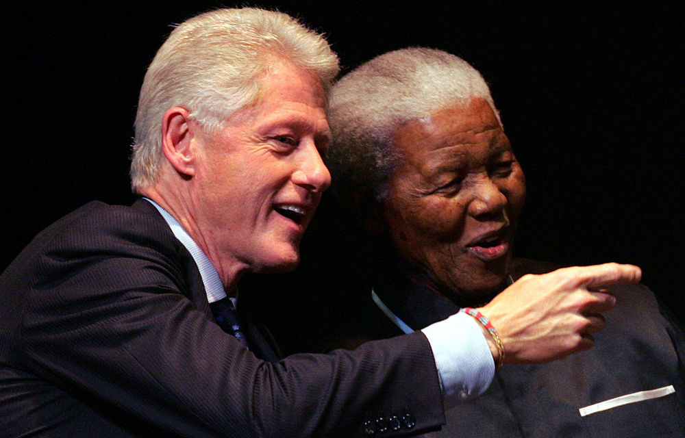 Nelson Mandela listens to former US president Bill Clinton during the third Nelson Mandela Annual Lecture on July 19