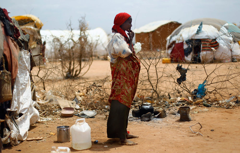 A refugee poses outside her hut in Dagahaley refugee camp north of Dadaab