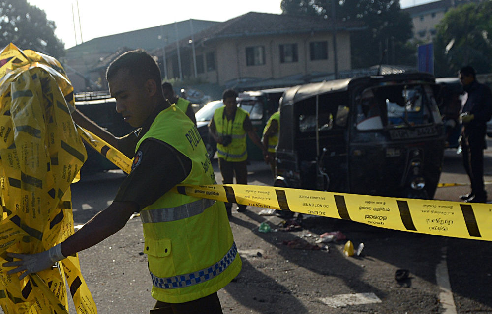 Security personnel examine a three-wheel taxi allegedly used by inmates to escape from the Welika maximum prison in Colombo.