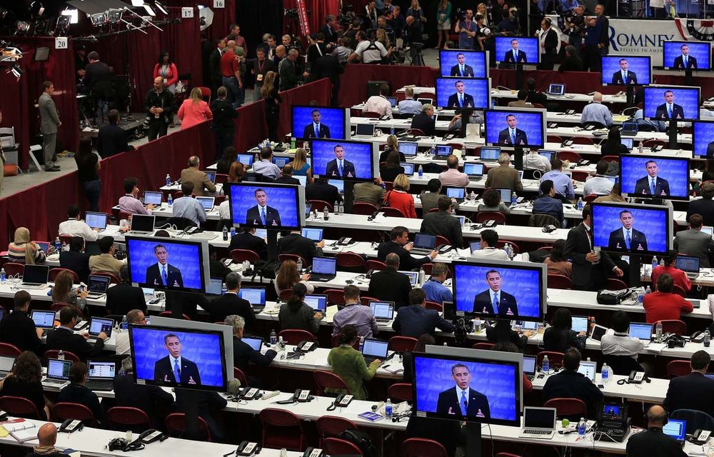 Reporters watch the debate between President Barack Obama and Mitt Romney.