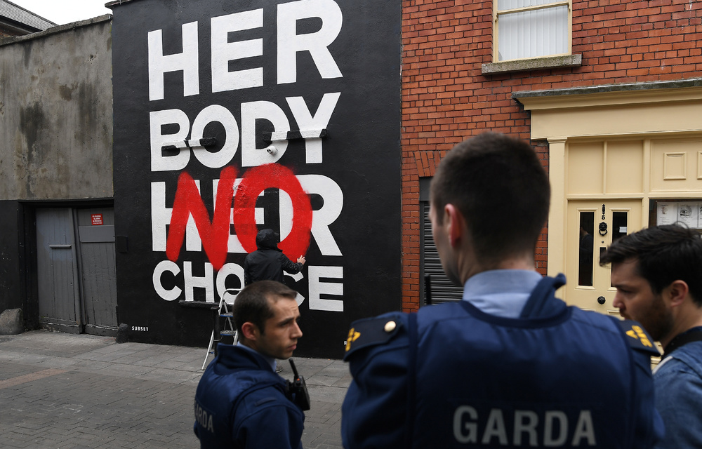 Police are seen at a new Pro-Choice mural by a graffiti artist collective called 'Subset' ahead of a 25th May referendum on abortion law